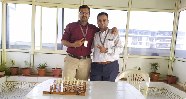 employees participating in a chess tournament promoting strategy and focus